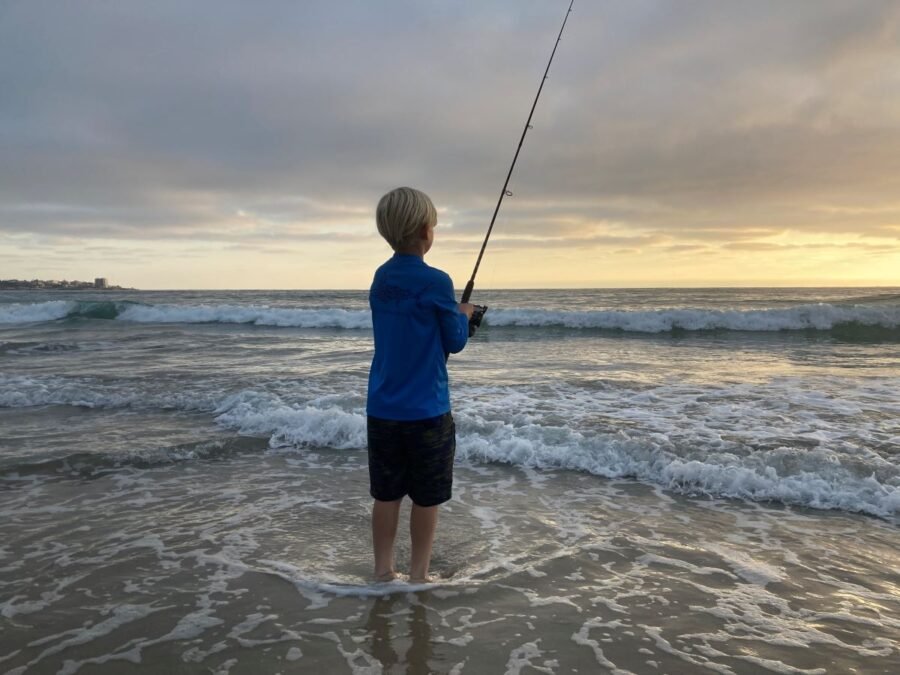 kid fishing at the beach