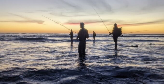 fishing buddies at sunset finding the best surf fishing spots