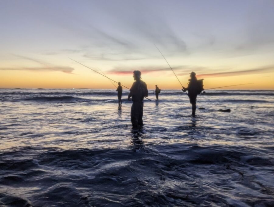 fishing buddies at sunset finding the best surf fishing spots