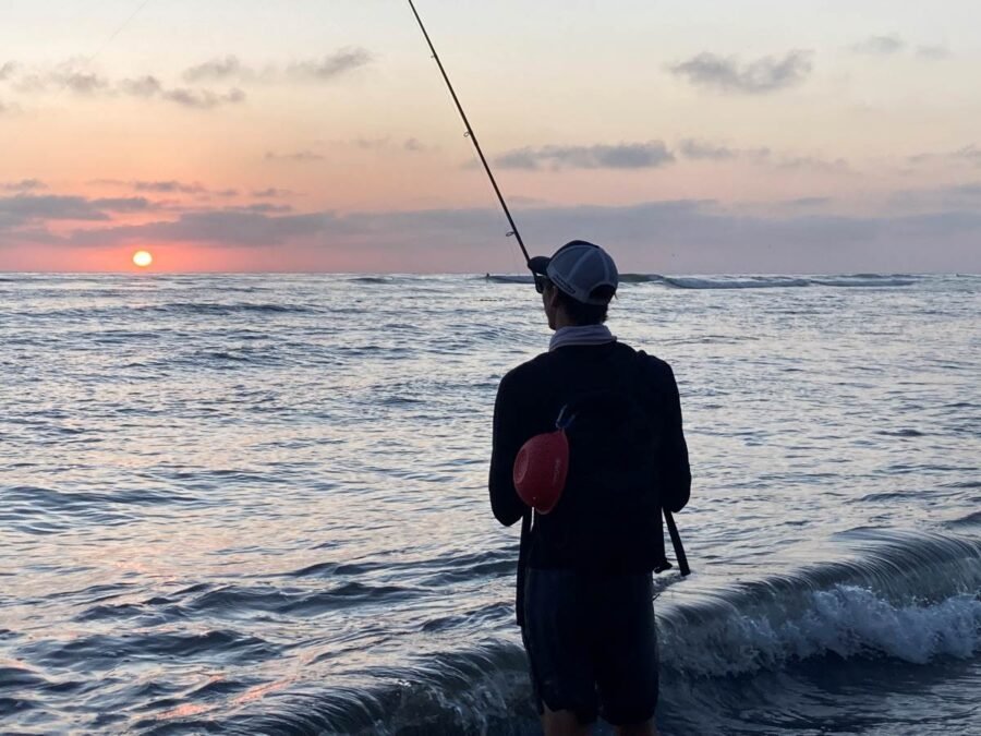 surf fisherman reeling