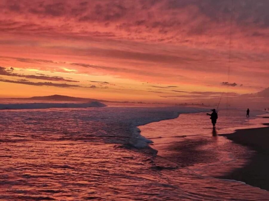 surf fishermen fishing at the beach