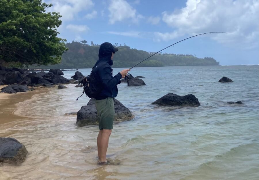 surf fishing near rocks at low tide